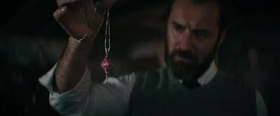 Albus Dumbledore (Jude Law) with Gellert Grindelwald's pendant in the 'Fantastic Beasts: The Secrets of Dumbledore' trailer. Photo: YouTube / Warner Bros Pictures