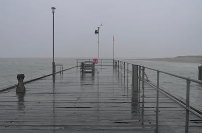The deserted pier on a rainy day in Aberdovey, Wales. James Langton for The National