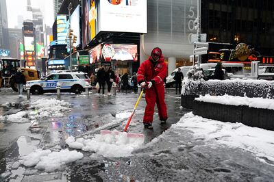 A worker clears snow in Times Square in Manhattan on Friday. Reuters