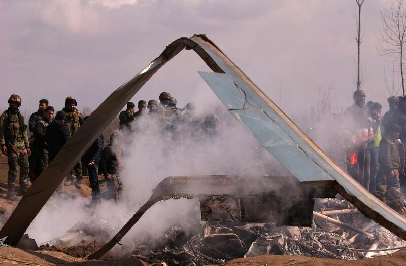 Indian soldiers stand next to the wreckage of the Indian Air Force's helicopter after it crashed in Budgam district in Kashmir. Reuters