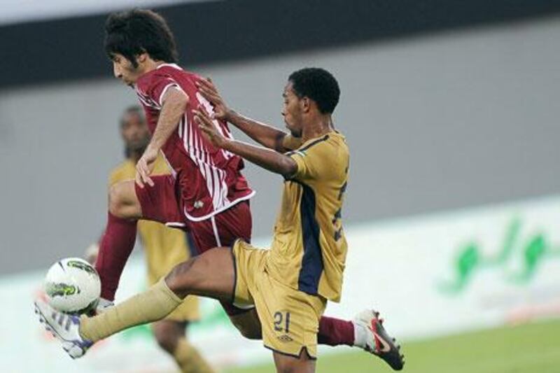With Dubai playing his Al Wahda team, in red, to a 1-1 tie, coach Josef Hickersberger could hear the fans shouting their disappointment. '“Our fans are right to be angry because they expected us to win this game and we couldn’t deliver,' he said.
