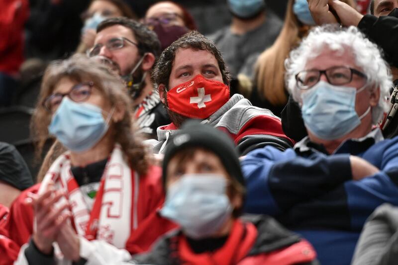 Spectators wearing face masks watch the Swiss National League ice hockey match between Lausanne HC and SCL Tigers in Lausanne. AFP