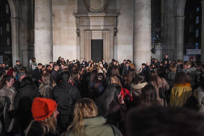 Crowds of people listen to a busker in Covent Garden. Getty Images