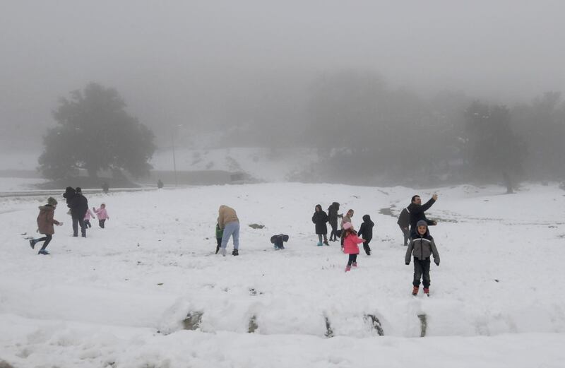 Tunisian families enjoy the snow in Ain Draham, north west Tunisia.  Inhabitants of the north west region have welcomed the first snowfall of the year.  AFP