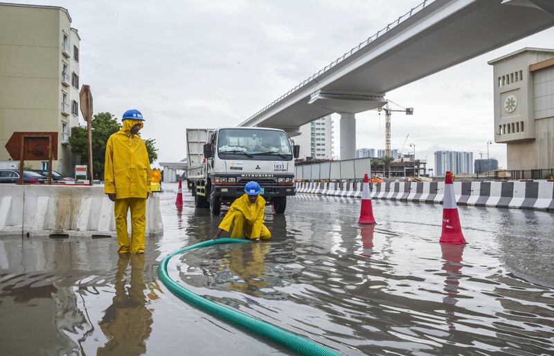 Dubai, United Arab Emirates- Workers sucking the flood out of the street in Discovery Gardens.  Leslie Pableo for The National