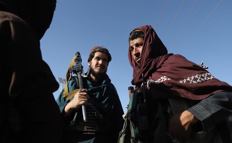 Alleged Taliban armed fighters walk with Afghan national army officers in the outskirt of Kabul during a three-day ceasefire on the second day of Eid al-Fitr, in the outskirt of Kabul, Afghanistan, on June 16, 2018. Jawad Jalali / EPA