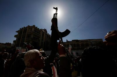 epa08950869 Yemenis hold up guns during an anti-US protest in Sana’a, Yemen, 20 January 2021. According to reports, US Secretary of State Tony Blinken has pledged to immediately review the US terrorist designation of Yemen's Houthi movement a day after Donald Trump’s government designated it as a Foreign Terrorist Organization (FTO).  EPA/YAHYA ARHAB