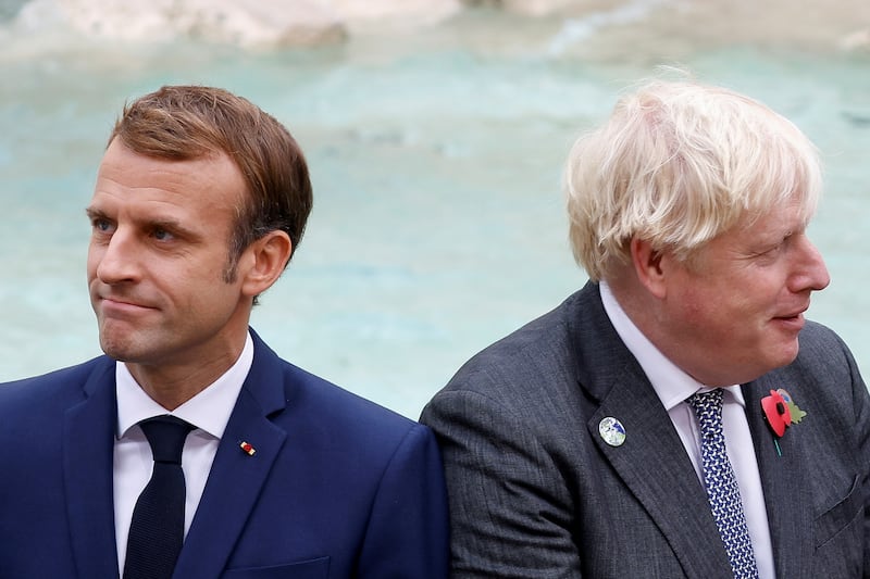 French President Emmanuel Macron and British Prime Minister Boris Johnson look on in front of the Trevi Fountain during the G20 summit in Rome. Reuters