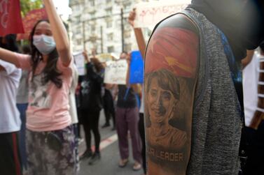 A protester with an image of ousted Myanmar leader Aung San Suu Kyi on the arm joins anti-coup protest march in Yangon, Myanmar, April 10, 2021. AP