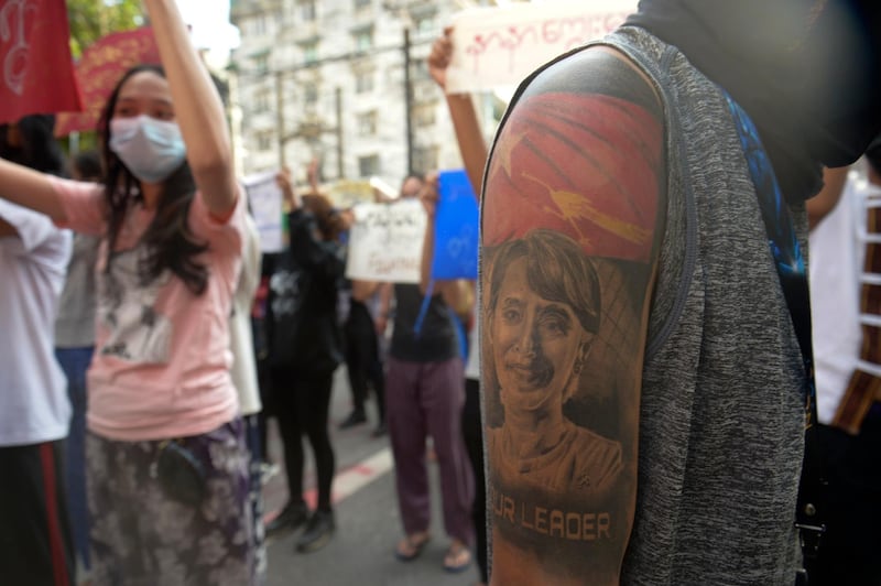 A protester with an image of ousted Myanmar leader Aung San Suu Kyi on the arm joins anti-coup protest march in Yangon, Myanmar, Saturday, April 10, 2021. Security forces in Myanmar cracked down heavily again on anti-coup protesters Friday even as the military downplayed reports of state violence.(AP Photo)