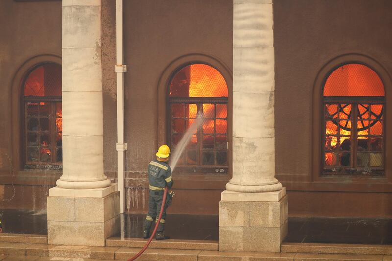 Firefighters fight flames at the University of Cape Town's Jagger Library. Reuters