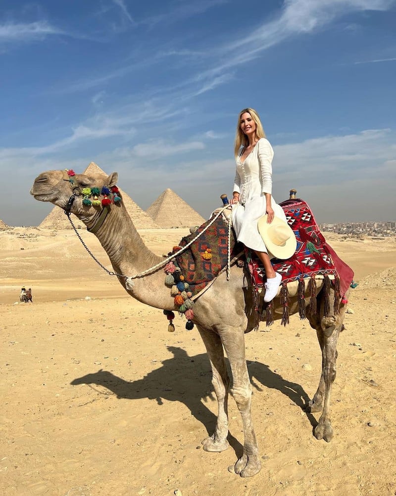 Trump riding a camel in front of the Pyramids of Giza