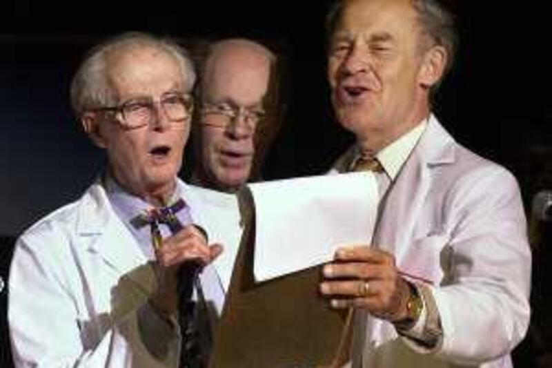 Nobel Prize winners, from left, William Lipscomb (Chemistry '76), Robert Wilson (Physics '78) and Dudley Herschbach (Chemistry '86) join in song during the Ig Nobel awards ceremony Thursday, Oct. 4, 2001, in Cambridge, Mass. Each year in a spoof of the real Nobel Prize, the Ig Nobel Prizes are awarded by actual Nobel Prize winners at Harvard University for achievements that "cannot or should not be reproduced." (AP Photo/Michael Dwyer)