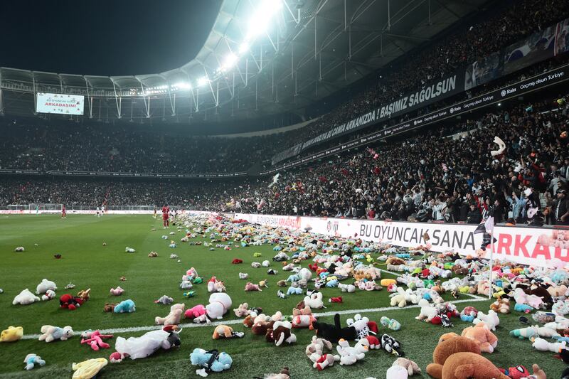 Fans throw toys on the pitch for children affected by earthquake during a Turkish Super League match between Besiktas and Antalyaspor. Reuters