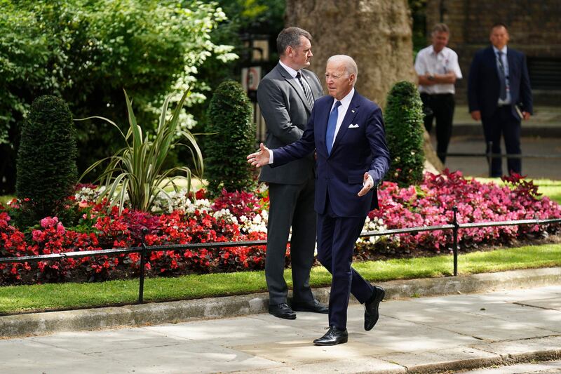 Mr Biden makes his way to 10 Downing Street. AP