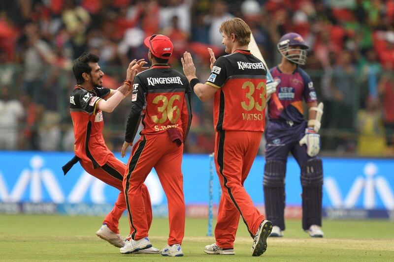 Royal Challengers bowler Shane Watson (2R) celebrates with teammates after the wicket of Rising Pune Supergiants captain and batsman MS Dhoni during the 2016 Indian Premier League (IPL) Twenty20 cricket match between Royal Challengers Bangalore and Rising Pune SuperGiants, at The M Chinnaswamy Stadium in Bangalore on May 7, 2016. Manjunath Kiran / AFP