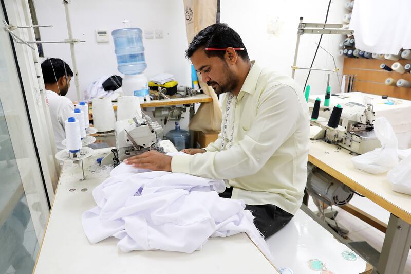 Tailors stitching Kanduras at the Al Nashama workshop in Dubai