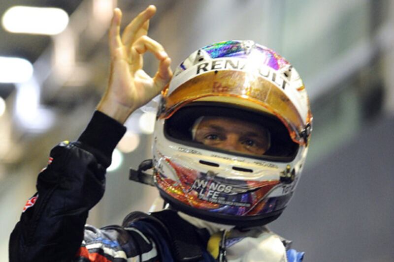 Red Bull-Renault driver Sebastian Vettel of Germany gestures after winning Formula One's Singapore Grand Prix on September 25, 2011. Sebastian Vettel demonstrated his supremacy when he won the Singapore Grand Prix to move within a point of becoming the youngest double world champion in Formula One history.   AFP PHOTO / Prakash SINGH

