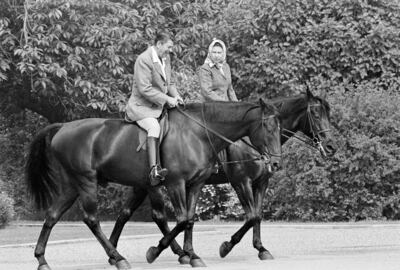 Former US president Ronald Reagan, on Centennial, and Queen Elizabeth II, on Burmese, ride on the grounds of Windsor Castle, England, in 1982. AP 