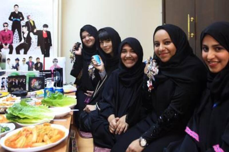 ABU DHABI - 02JUNE2011 - Sanaa Saoud al Hamzye (from left) Warda Saleh Bafaraj, Amina Ahmed al Ansari, Hanan Khailel al Amari and Latifa Ahmad al Romaithi Emirati girls who are Korean pop culture fanatic show they mobile keychains, posters and displayed all their collections on they lunch table at Hankook Korean restaurant on Thursday in Abu Dhabi. Ravindranath K / The National