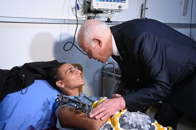 President Kais Saied visits an injured Palestinian, who has been evacuated from the Gaza Strip, in hospital in Tunis. Tunisian Presidency / via Reuters
