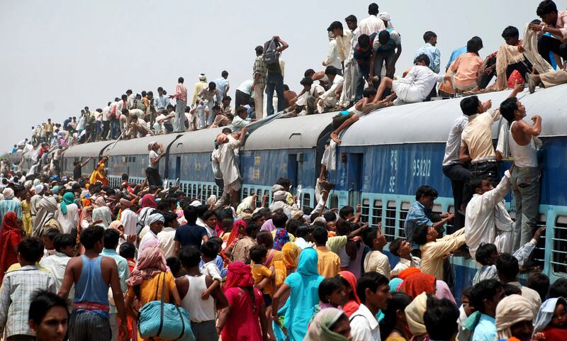 Hindu devotees try to board a crowded passenger train to take part in the 'Guru Purnima' festival in Goverdhan town, near the northern Indian city of Mathur. Reuters