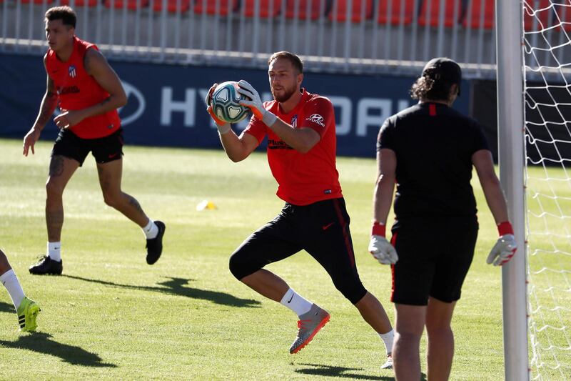 Atletico goalkeeper Jan Oblak makes a catch.