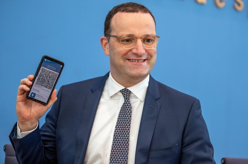 BERLIN, GERMANY - JUNE 10: German Health Minister Jens Spahn presents the CovPass app during a press conference announcing the CovPass vaccination certificates for smartphones on June 10, 2021 in Berlin, Germany. CovPass will provide international certification for those who have been fully vaccinated against COVID-19. Countries across the EU have been working on a common platform for digital vaccination certification in particular to promote international summer travel and tourism. (Photo by Andreas Gora - Pool/Getty Images)