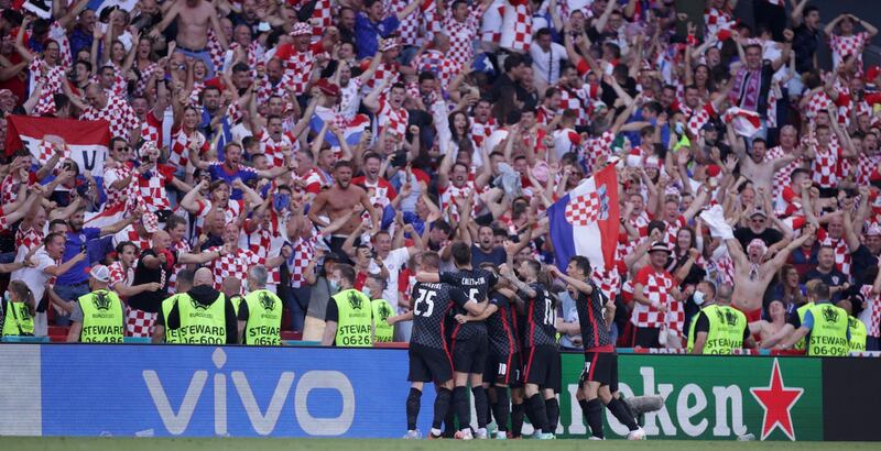 Croatia players and fans celebrate their third goal.