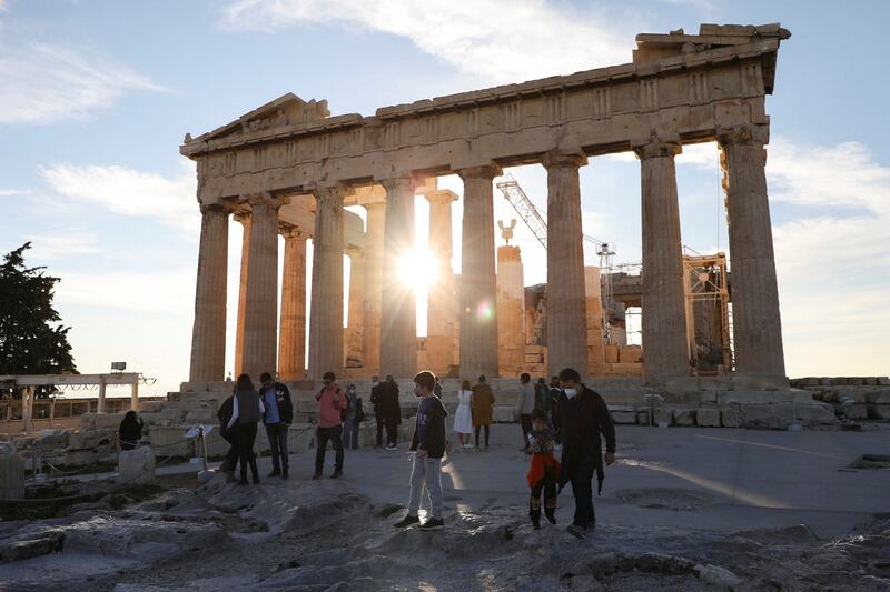 People wearing protective face masks visit the Parthenon in Greece amid the coronavirus pandemic. Reuters