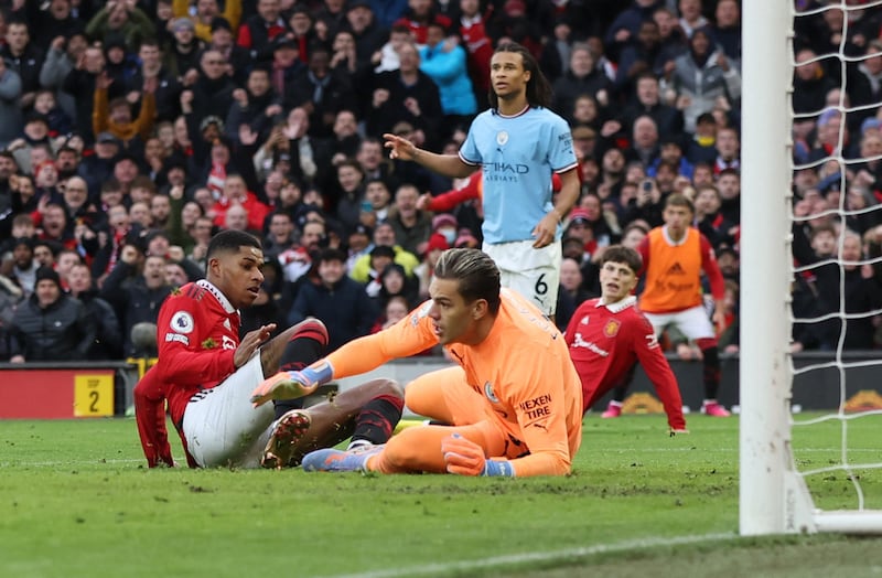 United's Marcus Rashford scores their second goal past Manchester City's Ederson. Reuters