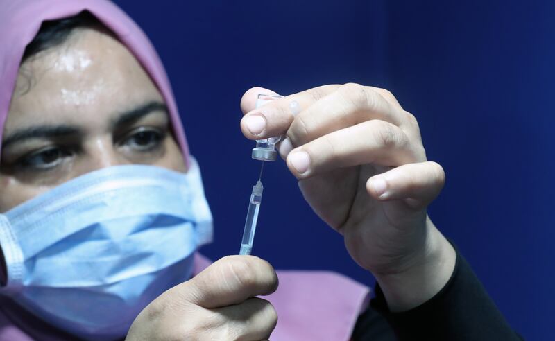A nurse prepares a vaccine against Covid-19 at a vaccination centre operating at Sadat station on the Cairo Metro. EPA