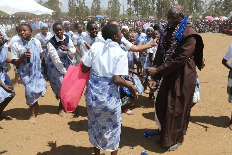 Peter Mokaya Tabichi a Kenyan science teacher and Franciscan friar at the Keriko Mixed Day Secondary School in Pwani Village of Njoro,  Nakuru County,  located 185 km from the capital city of Nairobi in Kenya dance with his students at the school on the 30th March 2019 during his home coming reception.  Tabichi won the Global teacher award last week. Photo/Fredrick Omondi/Kenya