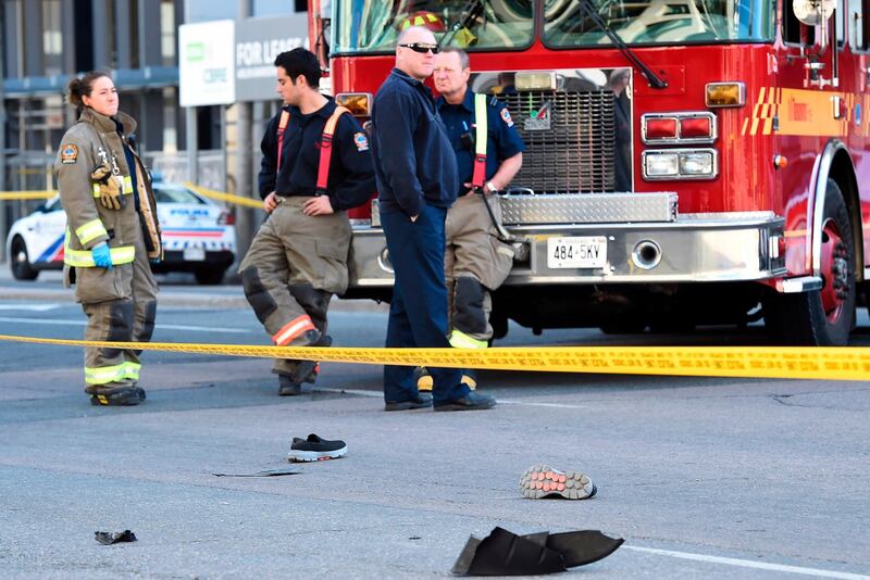 Shoes lay on the street as first responders secure the area in Toronto. The driver of the van was taken into custody, Canadian police said. Nathan Denette/The Canadian Press via AP