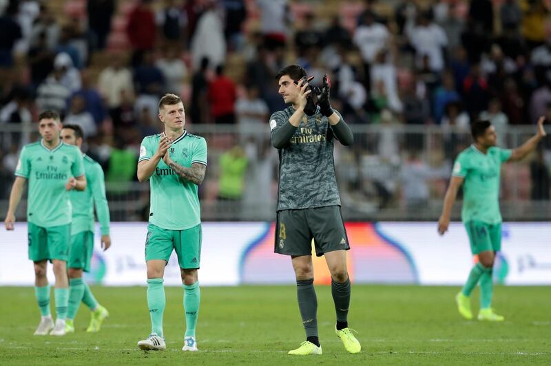 Real Madrid's Toni Kroos, center left, and goalkeeper Thibaut Courtois applaud at the end of the Spanish Super Cup semifinal soccer match between Real Madrid and Valencia at King Abdullah stadium in Jiddah, Saudi Arabia, Wednesday, Jan. 8, 2020. Real Madrid won 3-1. (AP Photo/Hassan Ammar)