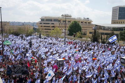 Thousands of Israelis wave flags during a protest in Jerusalem. Reuters