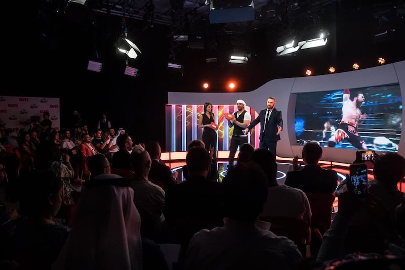 From left, Nathalie Mamo and Moen Al Bastaki, who will present WWE Wal300ha, with Syrian-Canadian wrestler Sami Zayn during the show’s launch in Dubai. Courtesy OSN  
