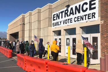 FILE - In this Friday, Oct. 30, 2020 file photo, people bundled against the cold stand in a slowly moving line to cast early votes at the Franklin County Board of Elections in Columbus, Ohio. Early voting ends in Ohio on Monday, Nov. 2. A surge in coronavirus cases across the country, including in key presidential battleground states, is creating mounting health and logistical concerns for voters, poll workers and political parties ahead of Election Day. (AP Photo/Andrew Welsh-Huggins)