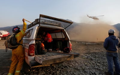 Members of civil protection prepare to work to extinguish a wildfire at the Sierra de Santiago, on the outskirts of Monterrey, Mexico March 20, 2021. REUTERS/Daniel Becerril