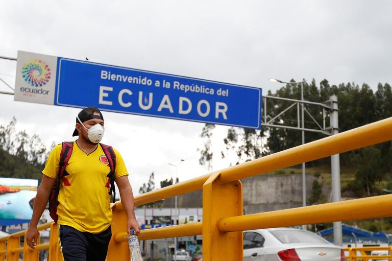 A man walks with a face mask, amid the new coronavirus outbreak, at Rumichaca border bridge in Tulcan, Ecuador. Reuters