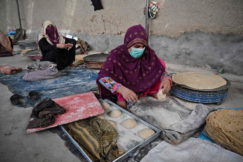 Women make flatbread in a factory in Kandahar. AFP