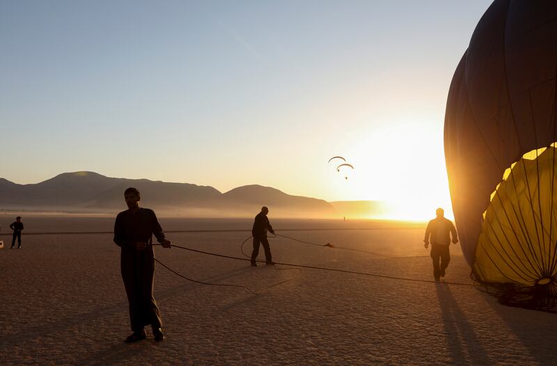 Men prepare a hot-air balloon in Wadi Rum, Jordan. Reuters