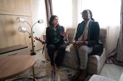 Home Secretary Suella Braverman, left, at a newly built house with Claudette Irere, Rwanda's Minister for Information.