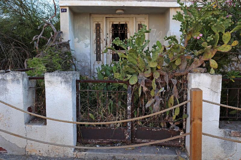 A prickly pear cactus blocks the entrance to a dilapidated house in Varosha.