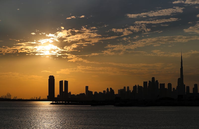 Dubai's skyline silhouetted near sunset