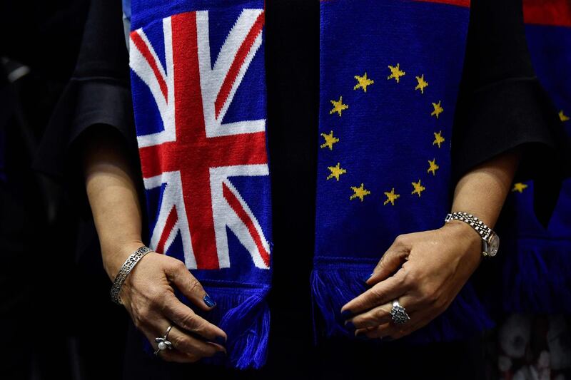 (FILES) In this file photograph taken on January 29, 2020, British members of the European Parliament from the Group of the Progressive Alliance of Socialists and Democrats pose for a group photograph wearing scarves depicting the European Union and the Union Jack flags at The Europa Building in Brussels. British and European Union officials on April 15, 2020, have agreed to schedule three new rounds of post-Brexit trade talks, starting next week, after the coronavirus epidemic disrupted their negotiating timetable.  A joint statement following a call between EU negotiator Michel Barnier and UK counterpart David Frost made no mention of postponing the end of Britain's transition out of the bloc beyond December 31. 
 / AFP / JOHN THYS
