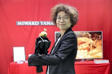 Miwako Yanagisawa, a jewellery designer displays a gold-plated hood on a a paper falcon at Adihex. Pawan Singh / The National
