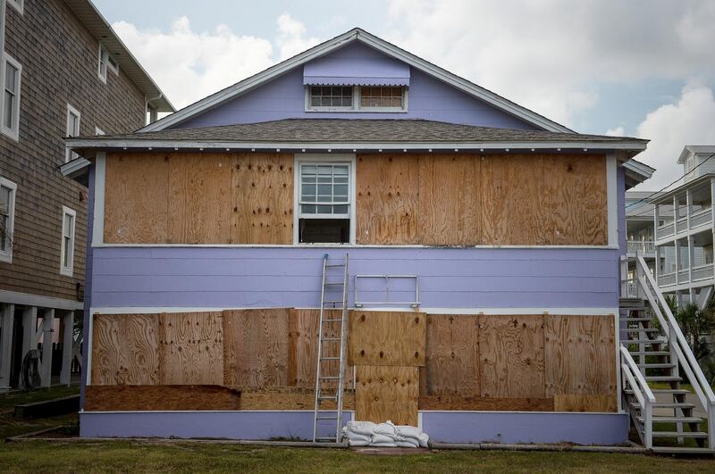 Plywood protects windows and doors of a property in Carolina Beach, North Carolina. Bloomberg