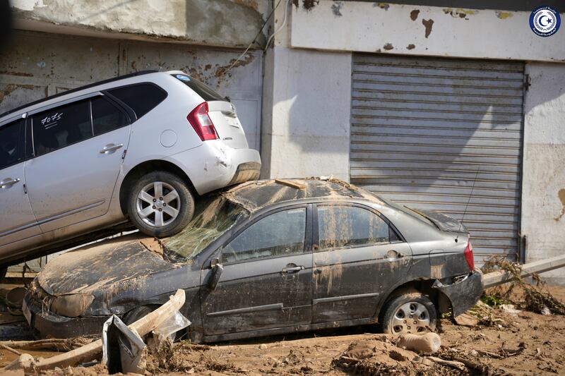 Cars stacked on top each other, after being washed away by floodwaters in Derna. AP