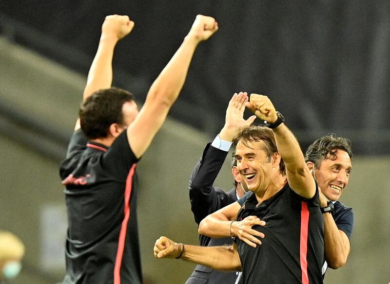 Sevilla coach Julen Lopetegui celebrates with staff after the match. Reuters